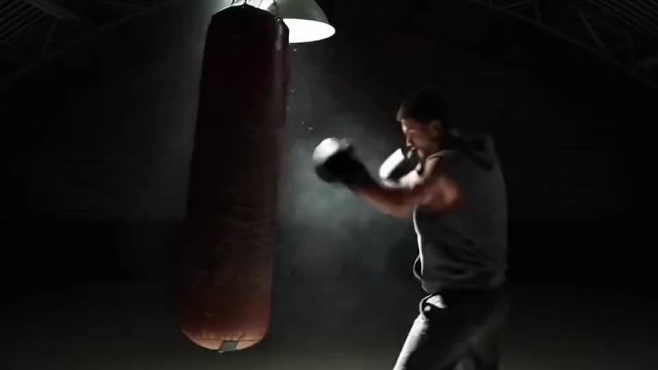 The bag swings under one lamp, dust hanging in the beam